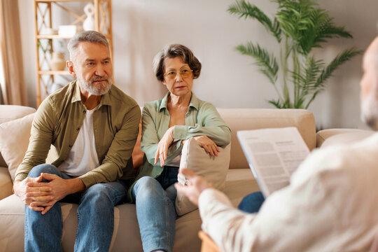 Medical advisor or psychologist during home visit with senior couple. Business agent planning with retired couple their future investment opportunities
