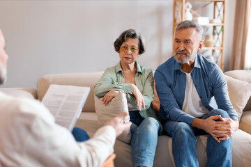 Medical advisor or psychologist during home visit with senior couple. Business agent planning with...