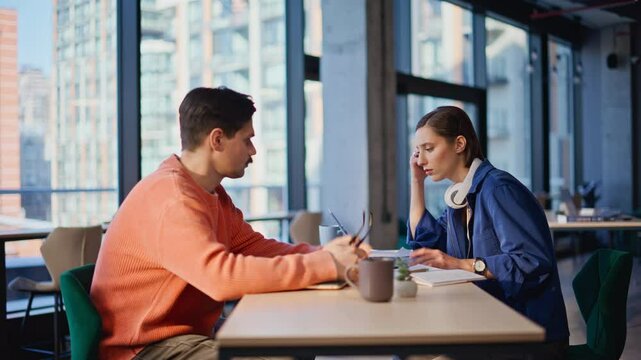 Worried partners solving problems at office closeup. Two stressed colleagues