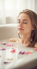 A woman relaxes peacefully in a milky bath filled with colorful flower petals, eyes closed in serene calm.