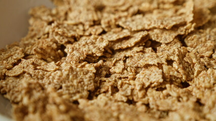 Closeup of dry cereal flakes in a bowl, ideal for breakfast and health-conscious diets