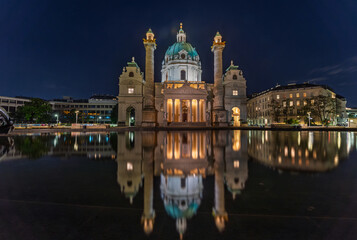 Illuminated Karlskirche in Vienna at night with baroque architecture
