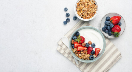 Yogurt with granola and berries in bowl