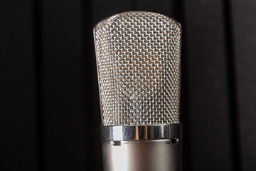 Silver studio microphone on a black background