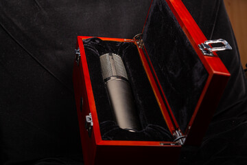 Professional silver studio microphone in a red box with locks