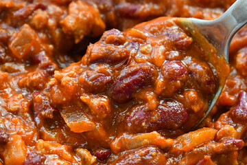 Chilli con carne on spoon. Traditional Mexican food.