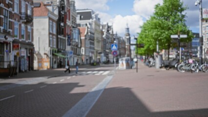 Blurred view of a european city street with historic buildings and people walking under a sunny sky, capturing the essence of urban life and architecture.