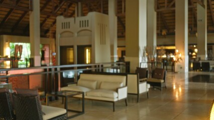 Luxury resort lobby with blurred background featuring plush furniture and subtle lighting,...
