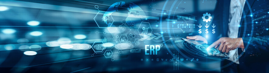A businessman using a tablet is analyzing ERP by integrating core business processes like finance, supply chain, and HR in real time, improving data flow, efficiency, and informed decision-making.