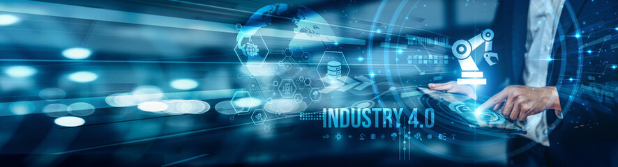 Businessman using tablet analyzing Industry 4.0 innovations to optimize automation, smart manufacturing, IoT integration, real-time data, AI applications, maintenance, and digital transformation.