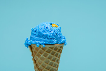 Blue bubble gum ice cream cone isolated on blue background