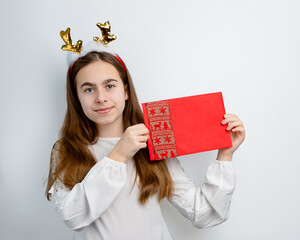 Cheerful girl in reindeer antlers on isolated gray background showing different funny emotions,...