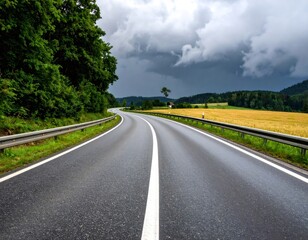 Fototapeta premium Empty asphalt road leading into dramatic storm clouds in rural landscape
