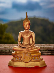 buddha staste of gold in green thailand garden