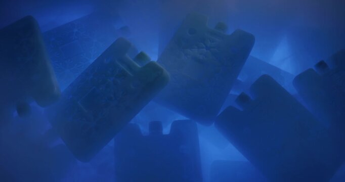 Portable cold accumulators of blue color in a steamy environment because of the difference of temperatures. Concept of saving cold in hot weather. 