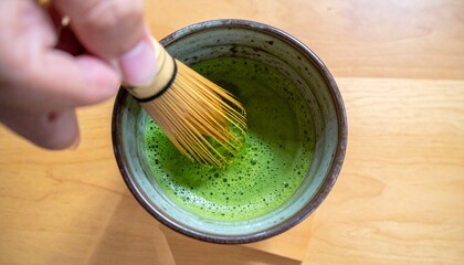 A matcha tea ceremony, capturing the vibrant green tea being whisked into a frothy delight
