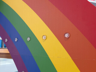 Colorful rainbow arc with embedded lights on display at a theme park