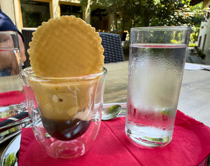 Italian affogato dessert served outdoors with glass of water