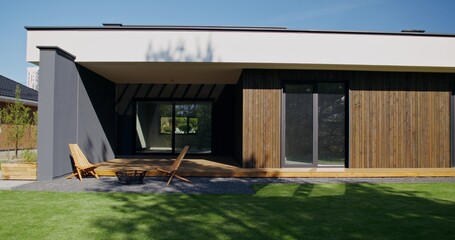 The facade of the house with panoramic windows, close-up. A sunny summer day, no people