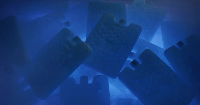 Portable cold accumulators of blue color in a steamy environment because of the difference of temperatures. Concept of saving cold in hot weather. 