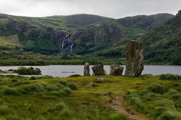 landscape with a lake and a stone circle