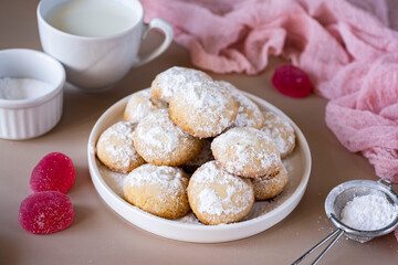 Sweet cookies on a white plate for breakfast on a pink background. Delicious cookies for dessert. Close-up.