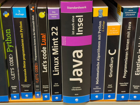 Villach, Austria - July 01, 2025: Collection of programming books on a shelf, featuring titles on Python, Java, and Linux, showcasing diverse coding languages and educational resources