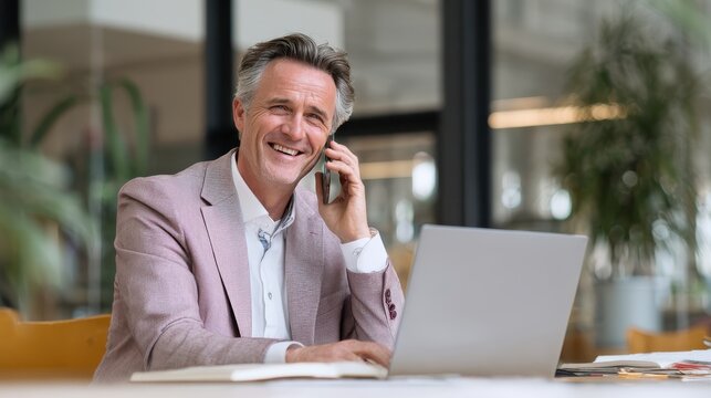 Happy middle aged business man talking on mobile phone working on laptop in office. Professional businessman executive wearing suit making call on cell using computer communicating, Generative AI