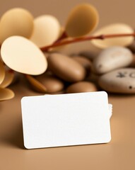 Blank business card mockup with beige background and decorative elements for branding presentation.