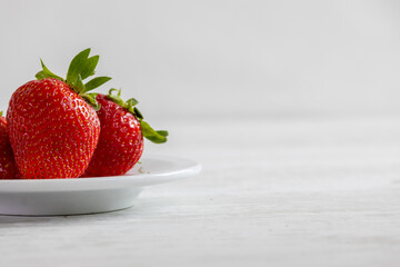  Fresh organic strawberries on a light background.