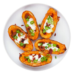 Loaded potato skins with cheese, sour cream, bacon and onions. Overhead view plate isolated on a white background.