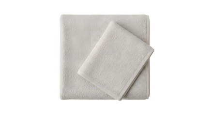 A simple arrangement of two folded towels in a light color on a plain dark background view from above