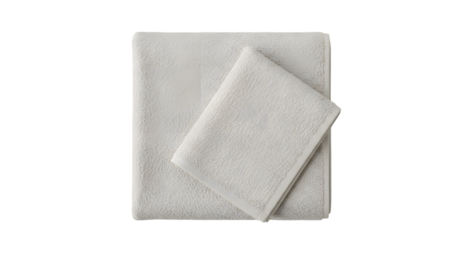 A simple arrangement of two folded towels in a light color on a plain dark background view from above
