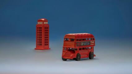 Close-up of a red toy bus and a London telephone booth.