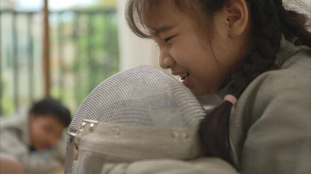 A girl in fencing gear is sitting on the sidelines, feeling disappoint for the unsuccessful game