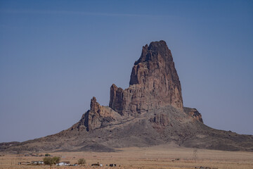 Fototapeta premium Agathlan / Agathla Peak is an eroded volcanic plug consisting of volcanic breccia / Intrusive breccia ( Ti ). south of Monument Valley, Arizona. U.S. Route 163 (U.S. Highway 163, US 163)