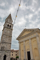 Historic bell tower and church with dramatic sky. Visnjan, Croatia.