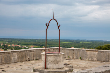Historic stone water well on terrace in Vizinada Croatia.