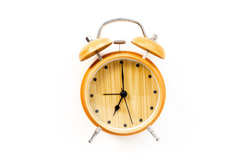 Vintage wooden alarm clock with bells at seven o'clock. Morning routine. In time concept
