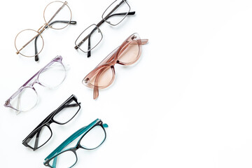 Many different styles of eyeglasses with lenses on white. Eye care and protection concept