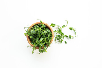 Wooden bowl of fresh sprouting microgreens, top view