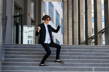 Dance, success or businessman in celebration at steps walking after a job interview, promotion or...