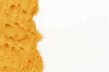 Frame of yellow sand texture on white background, close up top view. Abstract sand surface
