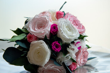 Close-up of bouquet of white red and pink roses on a table and white background. Concept: bridal bouquet. valentine's day.