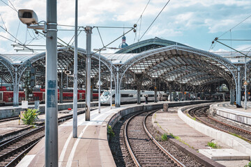 Train at a city railway station in Cologne with tracks and urban surroundings