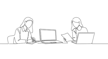 Women working together at a desk with laptops