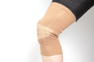 bandage for fixing the injured knee of the human leg on a white background. medicine and sports....