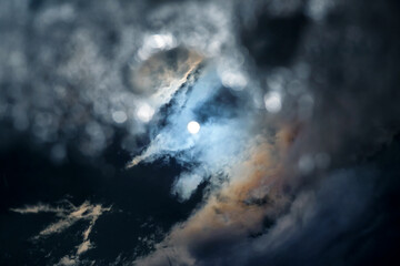 the reflection of the sun and clouds in a puddle of water
