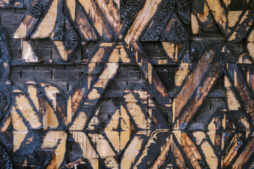 Charred wooden wall finishing surface. Decoration interior after fire.
