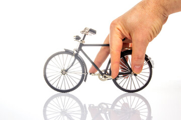 man hand on a bicycle model on a white background. cycling concept